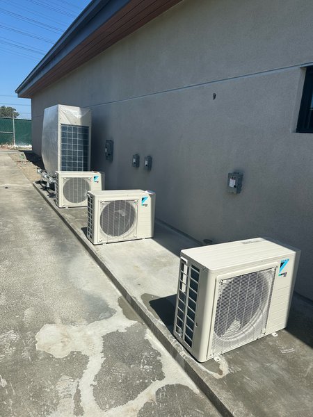 Daikin outdoor condensing units installed along a building wall