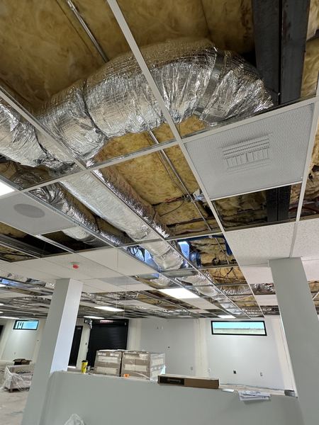 Insulated flex duct connected to supply diffusers above a new ceiling grid