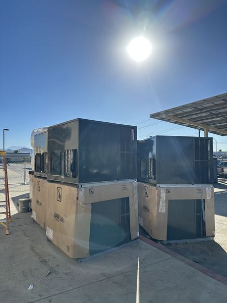Large packaged rooftop units staged on site