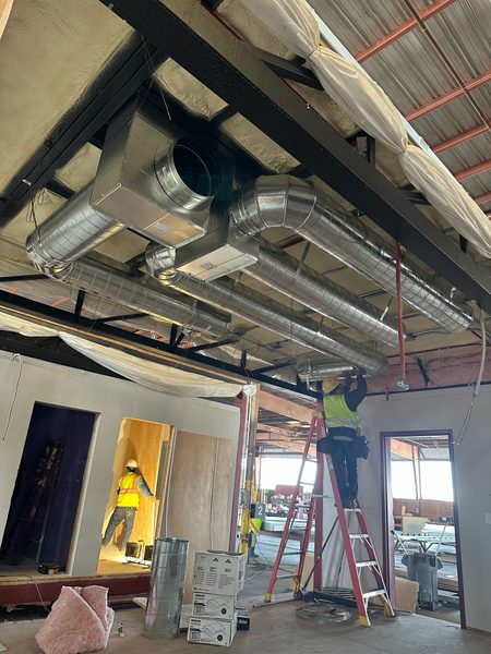 Spiral duct and plenum installed inside a modular building unit at the factory